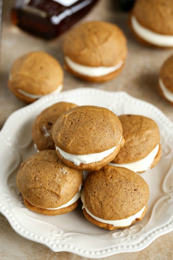 The classic New England dessert gets an update with pumpkin, spices, and maple! These Pumpkin Whoopie Pies with Maple Cream Cheese Frosting are the perfect fall dessert!