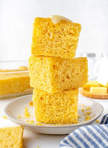 Three pieces of Sour Cream Cornbread stacked on top of each other.