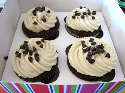 4 chocolate and peanut butter cupcakes in a cupcake box. 