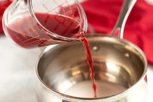 Pour the cherry juice into a saucepan.