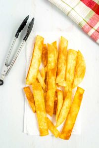 Fry tortilla strips in canola oil and sprinkle with salt.