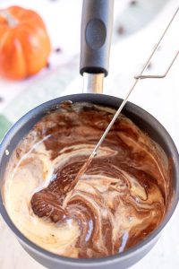 Combine the melted chocolate and the reserved cheesecake mixture.
