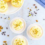 Frost the cupcakes and garnish with pistachios.
