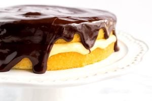 Side shot of a finished Boston cream pie cake.