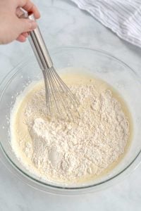 Whisk in the flour into the egg and milk mixture.