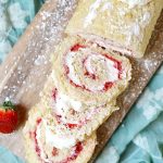 Slices of Strawberry Shortcake Roll Cake on a cutting board