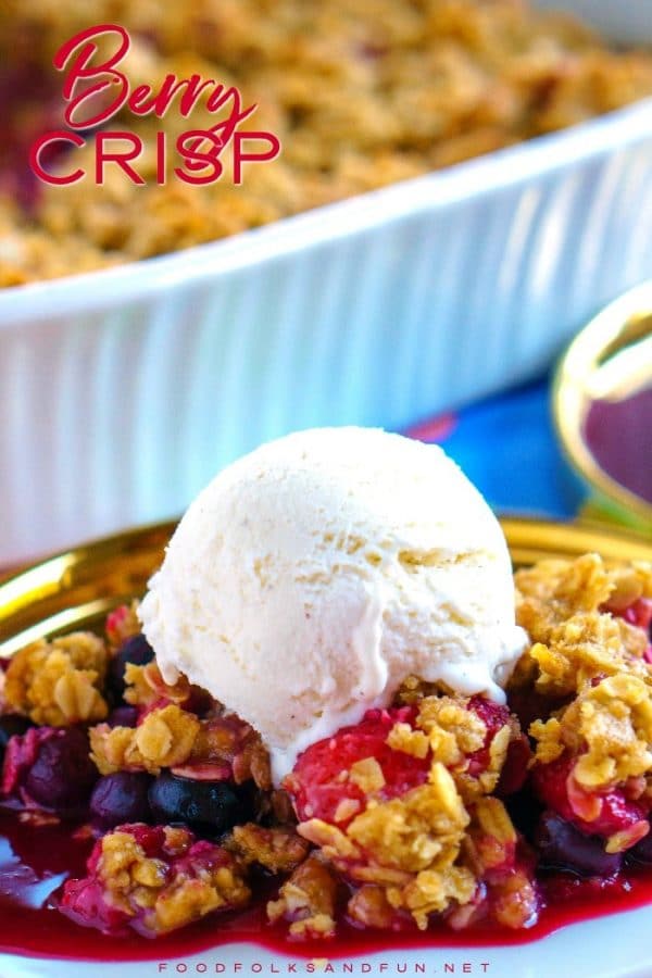 Berry crisp on a plate with ice cream on top.