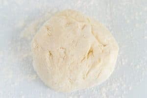 Knead the dough until a cohesive ball forms.