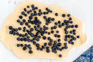 Distribute the blueberries all over the dough and press them lightly into the dough.