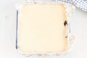 Pour the cheesecake batter on top of the cooked brownies and bake until the cheesecake is set.