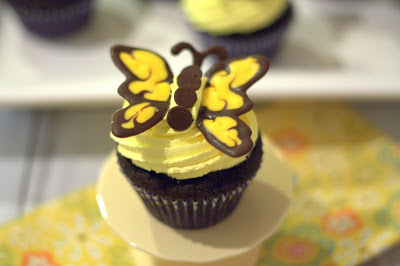 A close up of a dark chocolate butterfly cupcake