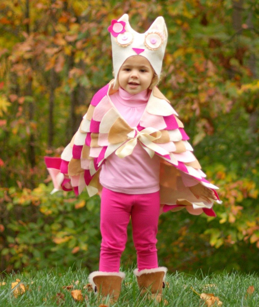 A little girl in a DIY pink owl costume