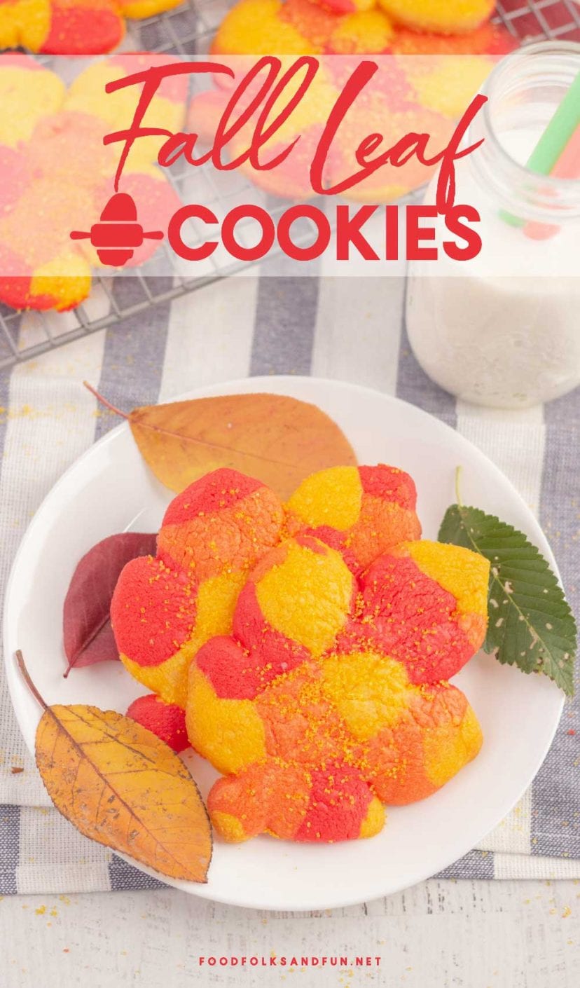 Fall leaf cookies dusted with sugar on a white plate.