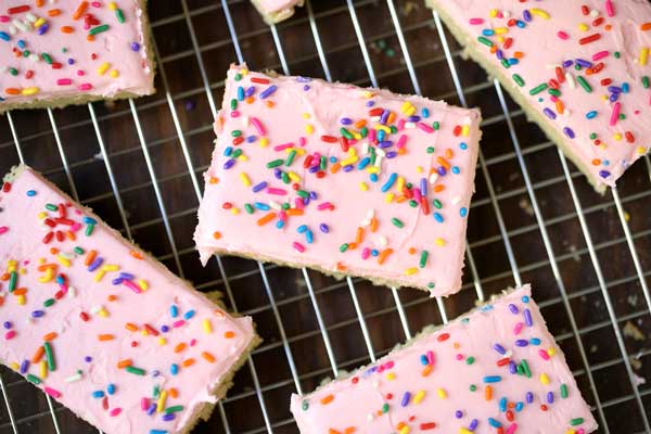 slices of soft and chewy sugar cookie bars on a wire rack