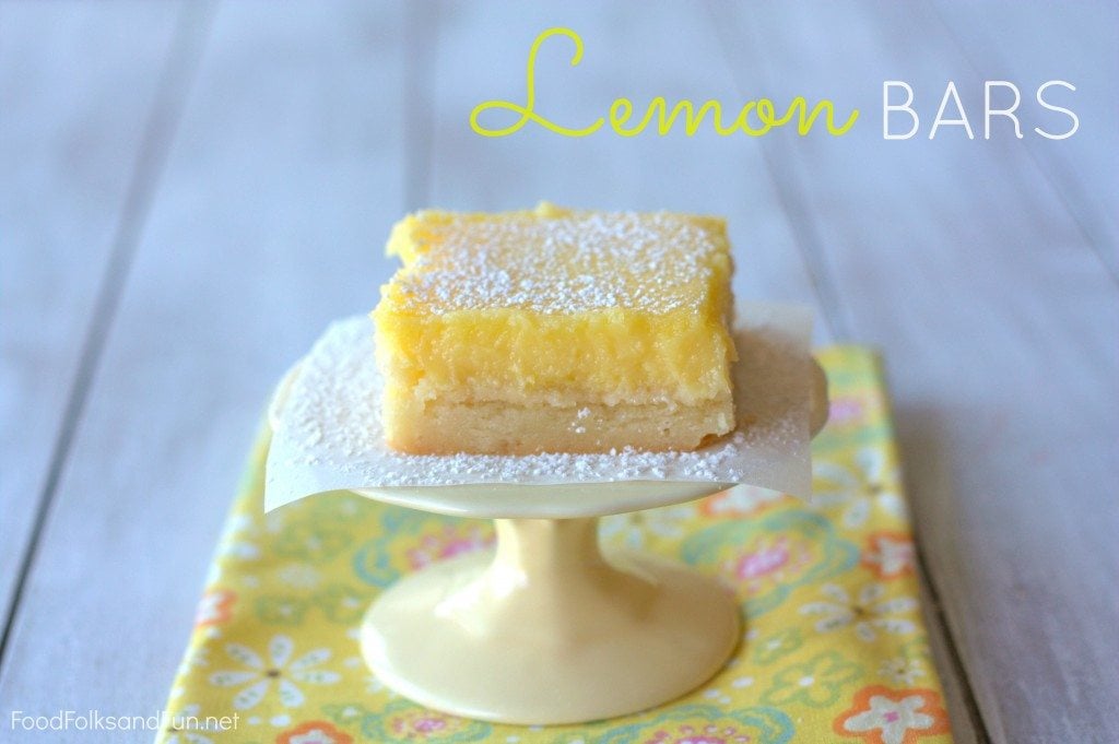 A slice of Zesty Lemon Bars on a cake stand with text overlay for Pinterest