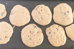 Blueberry Buckwheat Pancakes on a griddle