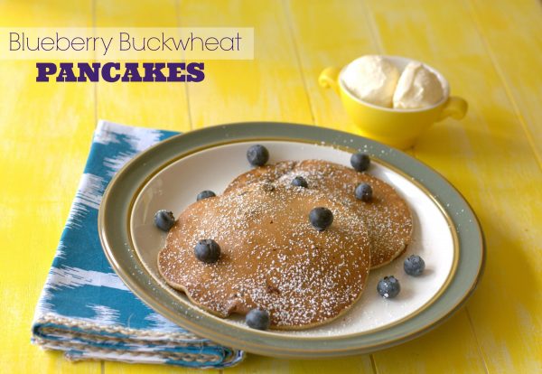 Blueberry Buckwheat Pancakes on a white plate with text overlay.
