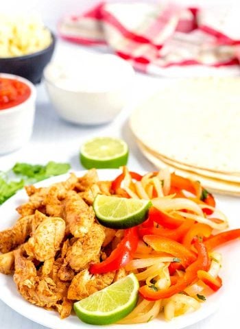 Chicken fajitas on a serving platter ready to be served.