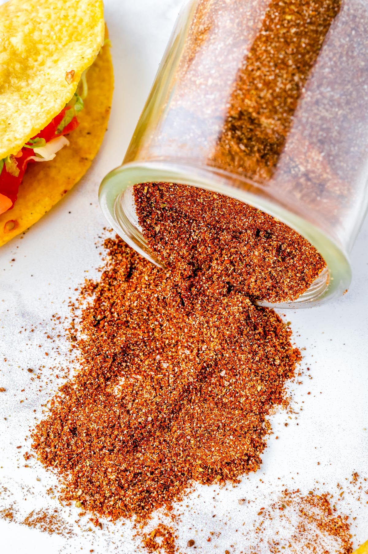Homemade Taco Seasoning in a jar that's been tipped over.