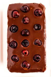 Spread ganache on top of cheesecake layer, dot with cherries, and chill for an hour.