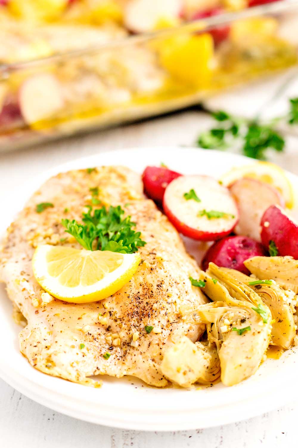 Baked Lemon Chicken on a plate with potatoes