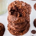 Five chocolate cookies staked on each other with a bite taken out of the top one.