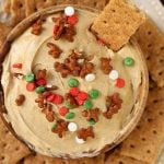 Overhead picture of cheesecake dip with a graham cracker dipped into it.