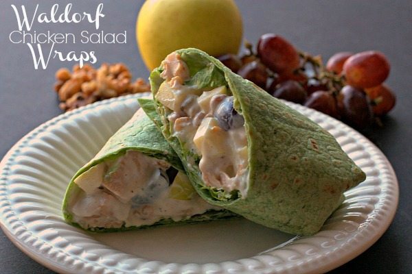 A sliced Waldorf Chicken Salad Wrap on a white plate. 