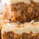 A close up picture of White Chocolate Blondies stacked on top of each other.