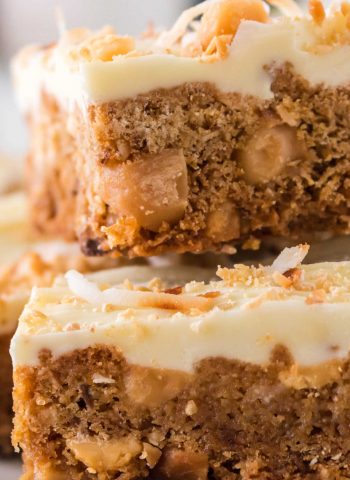 A close up picture of White Chocolate Blondies stacked on top of each other.