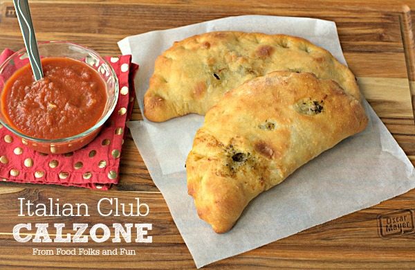 Two calzones on a table with text overlay for Pinterest