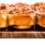 Finished sticky buns with bacon and caramel glaze with text overlay for Pinterest.