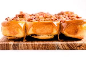 A closeup picture of the finished sticky buns on a wooden board.