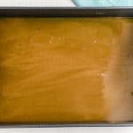 Pour the caramel glaze into the bottom of a 9x13-inch pan.
