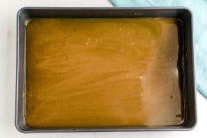 Pour the caramel glaze into the bottom of a 9x13-inch pan.