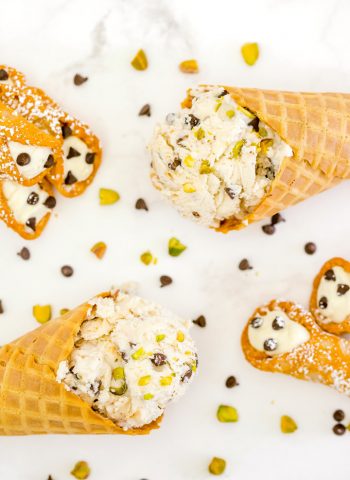 An overhead picture of 2 ice cream cones filled with cannoli ice cream.