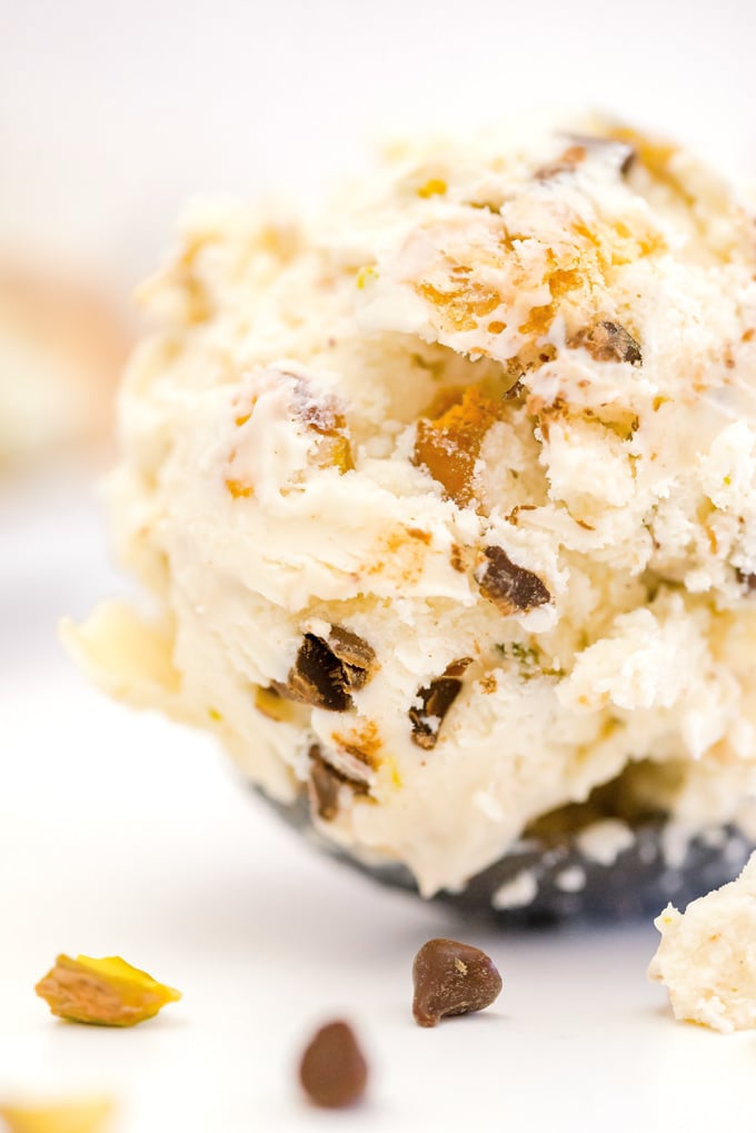 A coop of cannoli ice cream in an ice cream scoop.