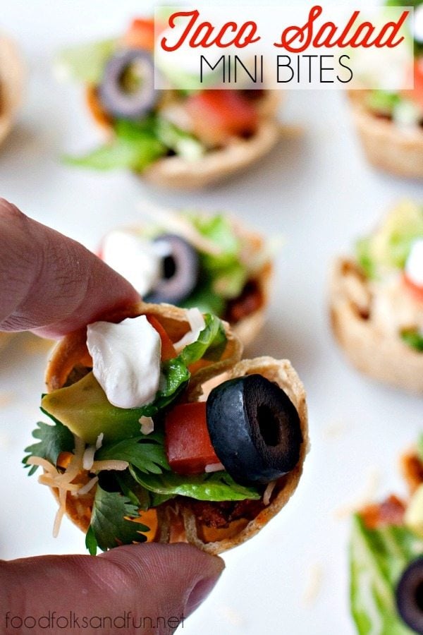 A close-up of Taco Salad Mini bites with more in the background on a plate