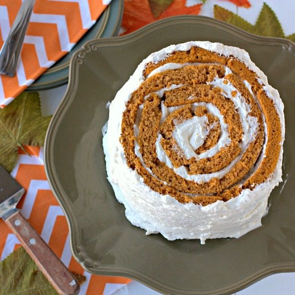 A top view of Pumpkin Blossom Cake, a roll-up cake, on a plate