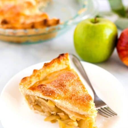 Deep Dish Apple Pie slice on a white plate.