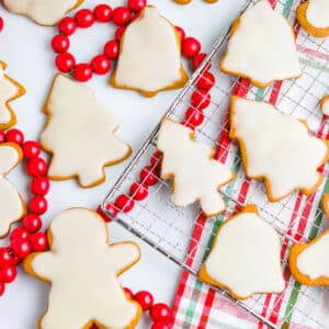 Christmas Gingerbread spread out on a counter with a festive tea towel and red garland nearby.