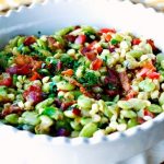 Succotash with bacon and scallions in a serving bowl