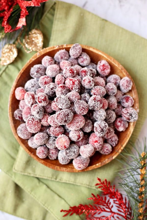 Overhead picture of sugared cranberries in a wooden bowl.
