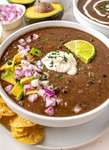 A close up picture of Black Bean Soup in a white bowl.