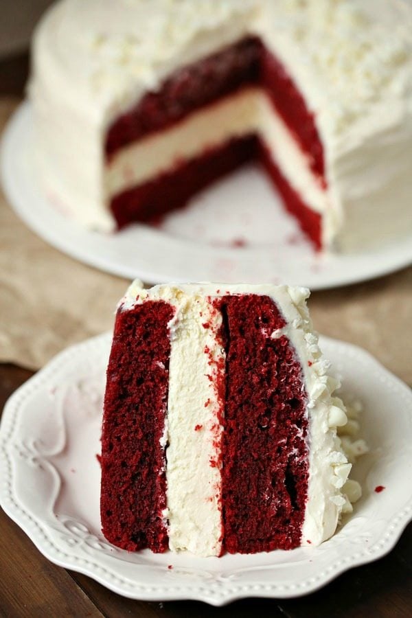 A close up of a piece of red velvet cheesecake on a plate.