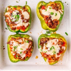 An overhead picture of the finned stuffed peppers with Italian sausage in a baking dish.