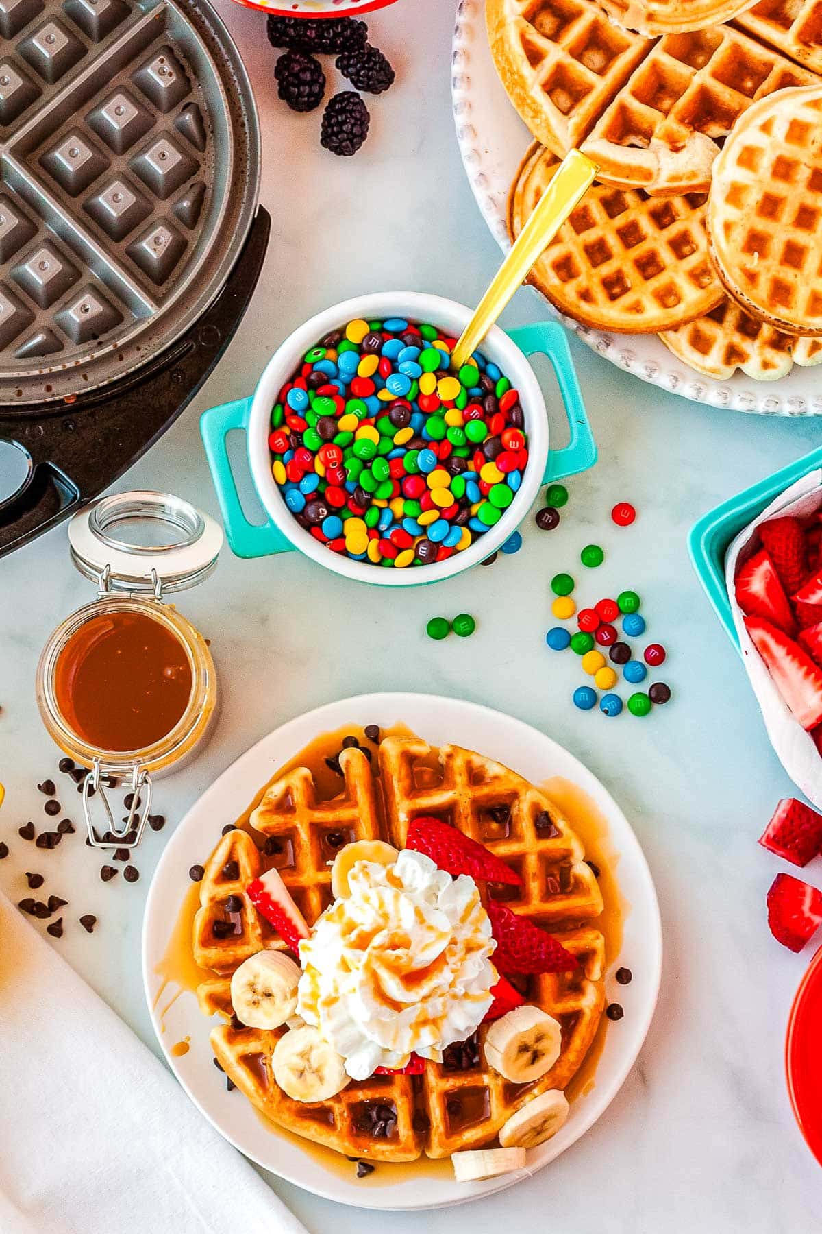An overhead picture of the various waffle bars toppings.