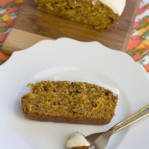 A slice of carrot cake on a white plate.