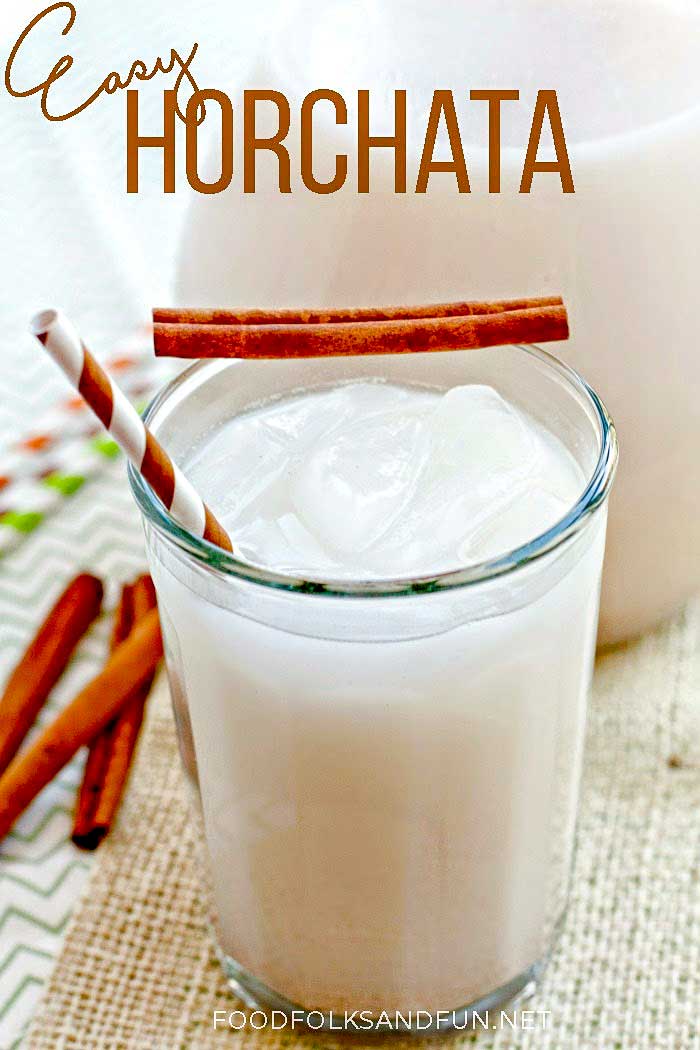 Homemade horchata in a glass garnished with cinnamon sticks.