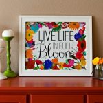 Live life in full bloom printable in a frame on a table